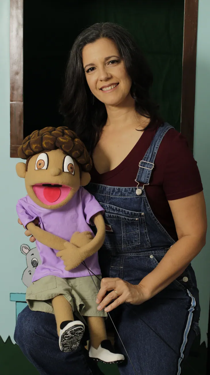 Margarita Sotomayor working with a puppet behind the scenes