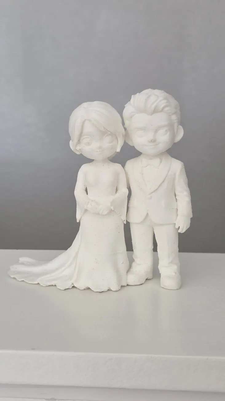 Unpainted sculpted couple displayed as a prototype