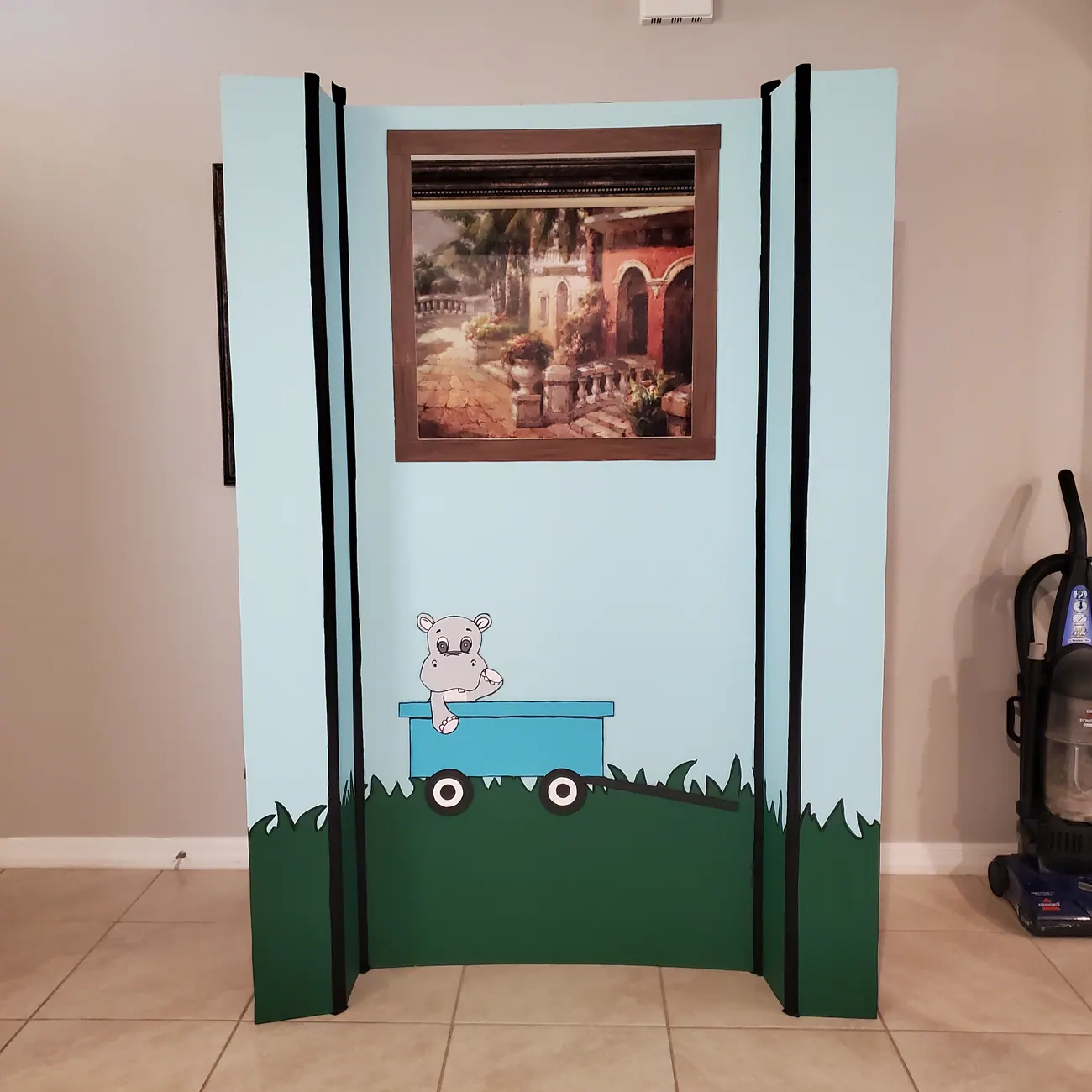 Painted decorative project with custom green framing and illustration.