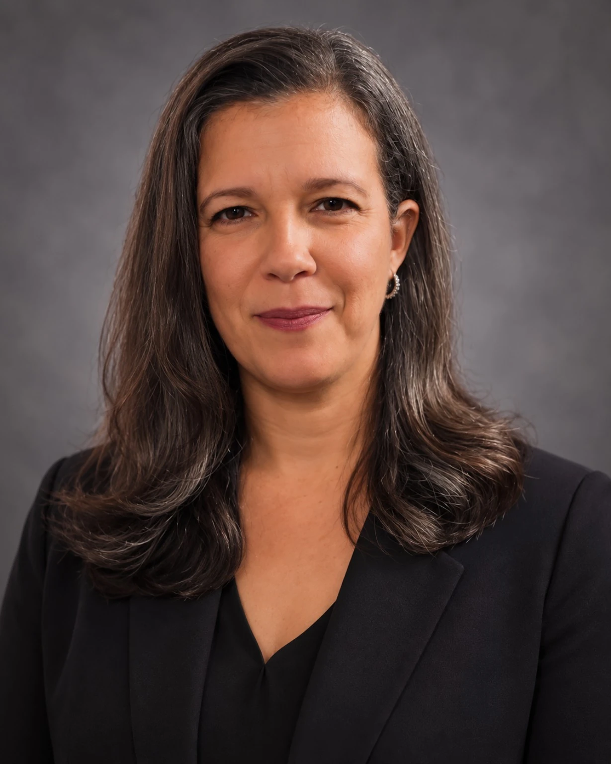 Professional headshot of Margarita Sotomayor against a neutral gray background
