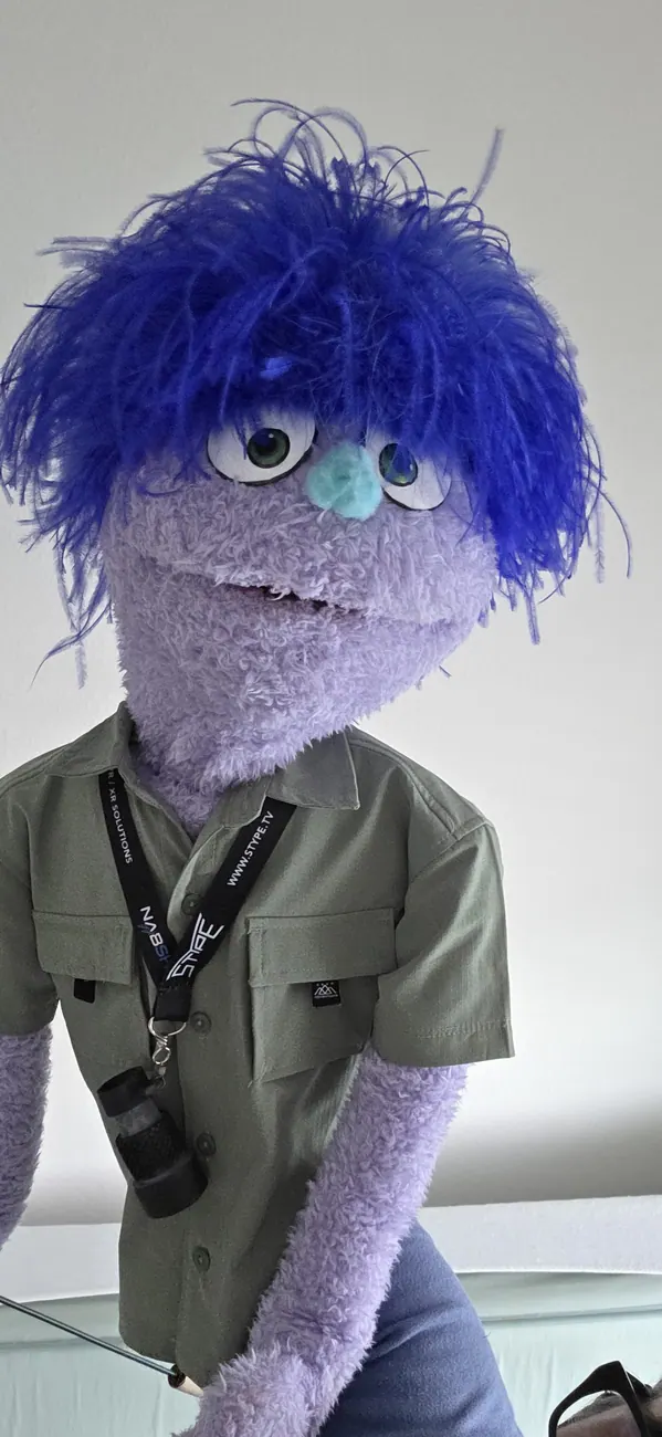 Handmade purple-haired character puppet in costume.